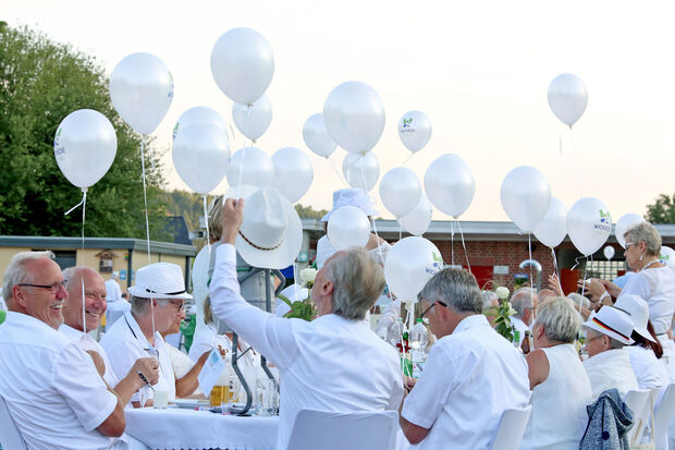 Die Teilnehmer des „Dîner en blanc“ der Gemeinde Wickede (Ruhr) ließen weiße Gasluftballons mit aufgedrucktem Gemeinde-Logo gen Himmel steigen. FOTO: ANDREAS DUNKER